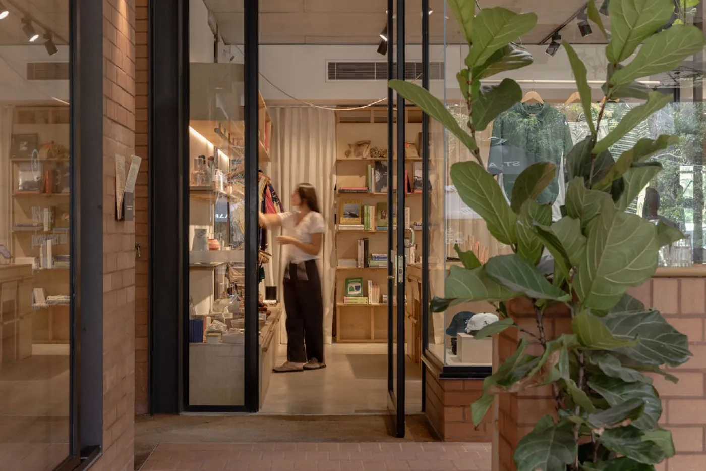 Browsing books and homewares at Kind Curations, Tugun